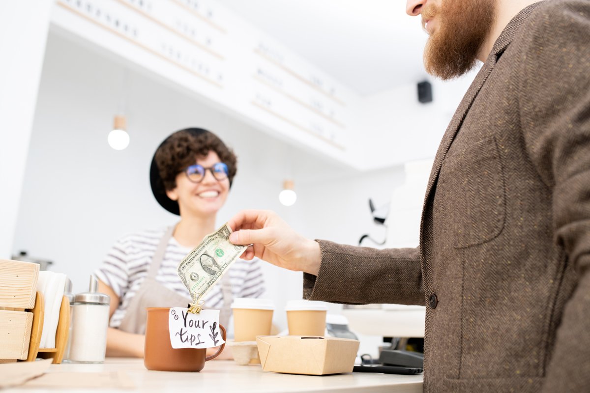 Man tipping barista