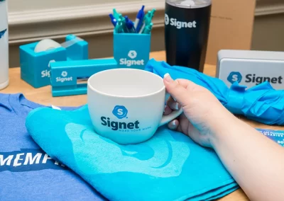 closeup of Signet branded products mug shirts pen holder tumbler